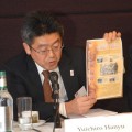 photo of Yuichiro Hanyu talking about and holding up a document about William Adams